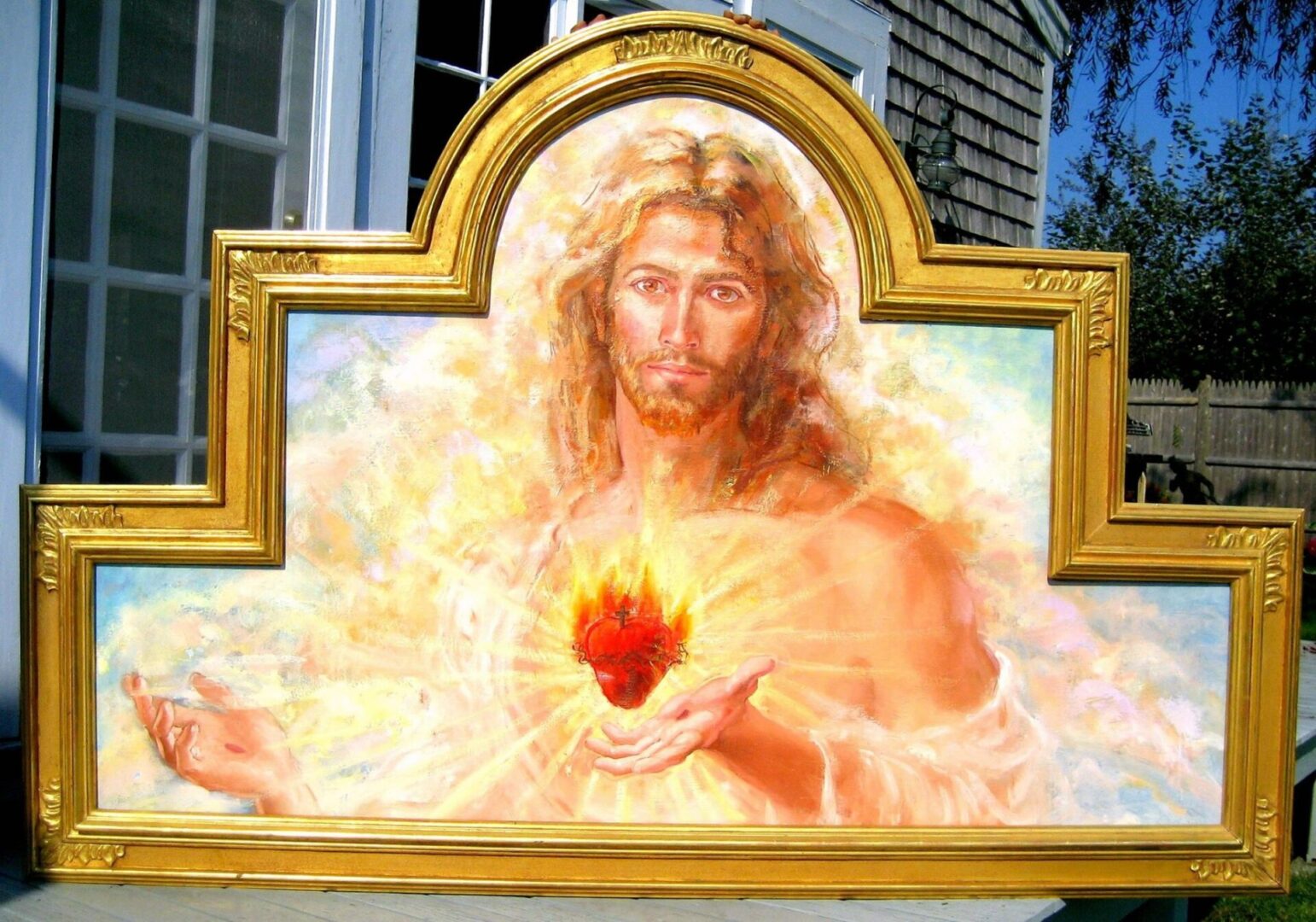 A painting of jesus holding the sacred heart.